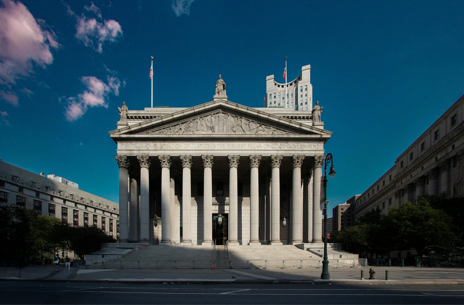 Front view of the Supreme Court building in New York City with blue skies.